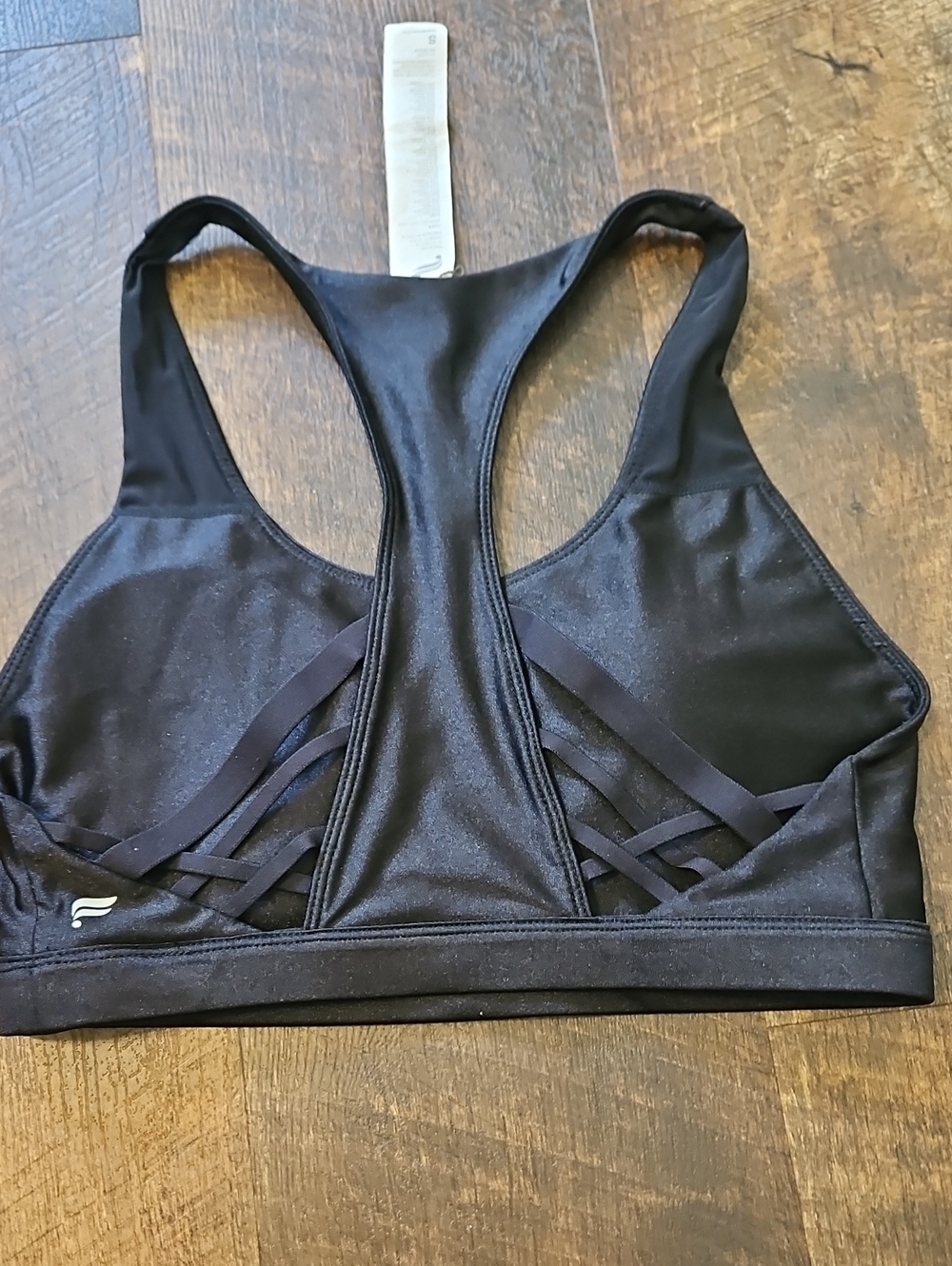 black Fabletics sports bra features a detailed criss-cross strap back